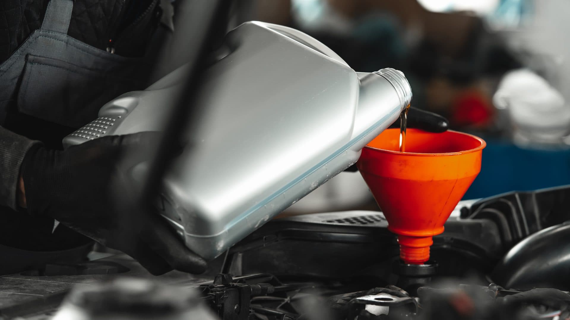 Mobile oil change service under an open hood